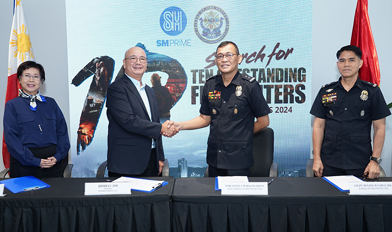 2 SM Prime President Jeffrey Lim second from left and Bureau of Fire Protection BFP Director Louie Puracan second from right shake hands to signify their commitment to the signing of the Memorandu